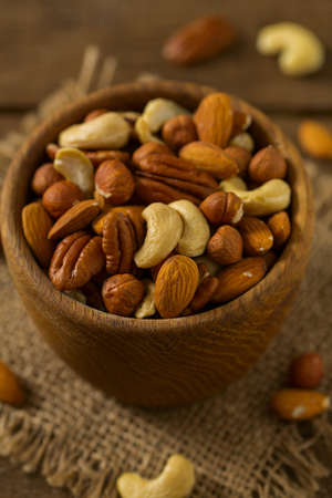 mixed nuts on wooden surface