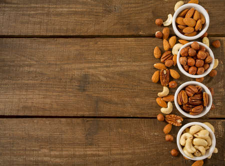 mixed nuts on wooden surface
