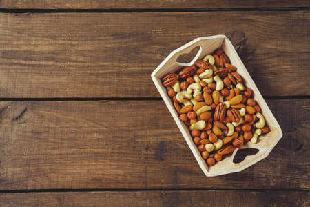 mixed nuts on wooden surfaceの写真素材