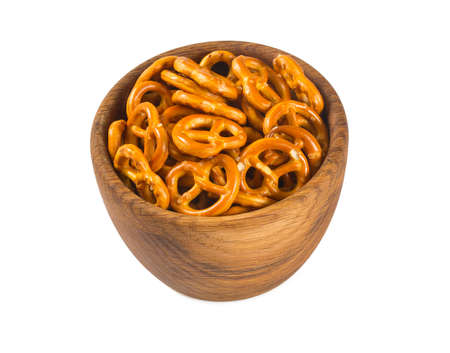 pretzels in a wooden bowl isolated on whiteの写真素材