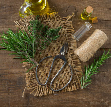 olive oil with herbs on wooden surfaceの写真素材