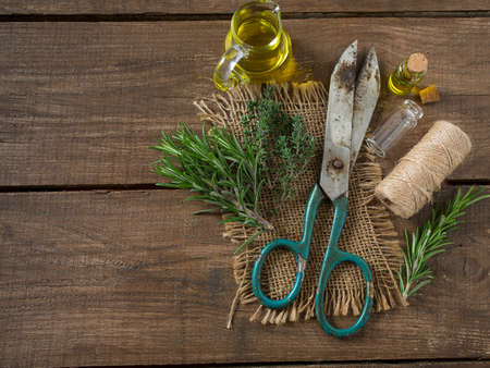 olive oil with herbs on wooden surfaceの写真素材