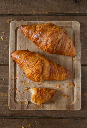 fresh croissant over woodの写真素材