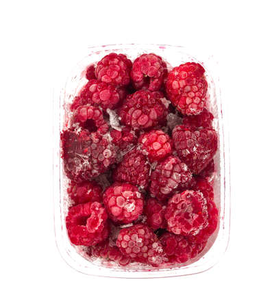 frozen raspberries in a plastic box isolated