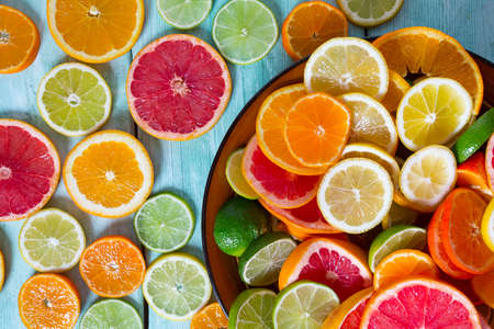 citrus fruit slices on turquoise backgroundの写真素材