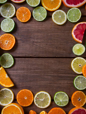 mixed citrus fruits on dark wooden backgroundの写真素材