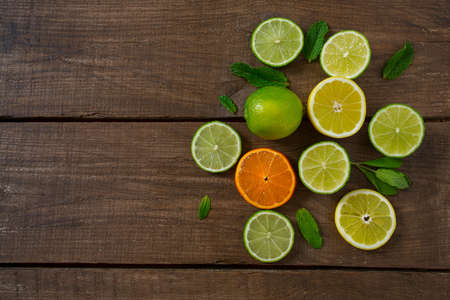 lemons and limes on wooden surface