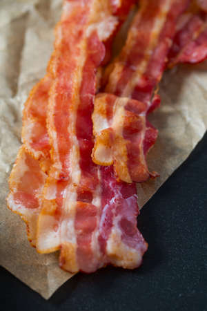 Fried bacon on wooden surfaceの写真素材