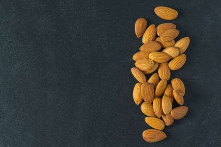 almonds on black surfaceの写真素材