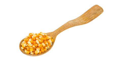 wooden spoon of dried corn isolated on white backgroundの写真素材
