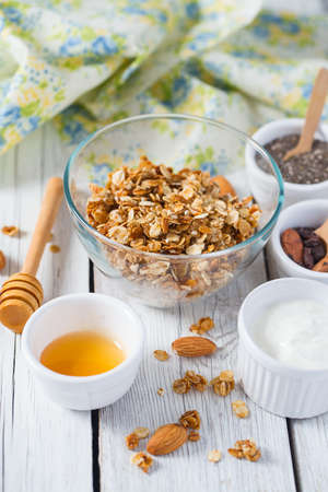 breakfast with granola on wooden surfaceの写真素材