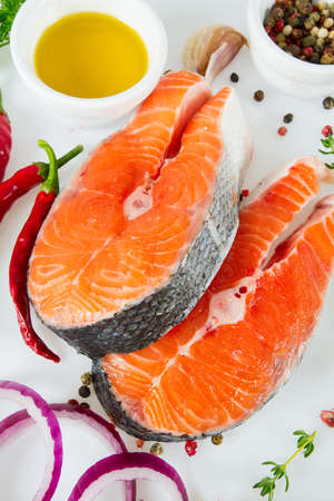 pieces of salmon and herbs over whiteの写真素材