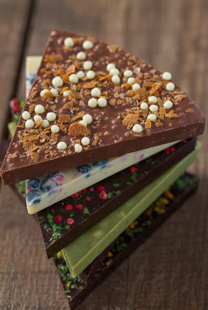 triangle slices of chocolate on wooden surface