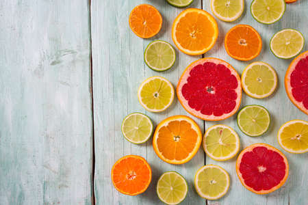 citrus fruit slices on turquoise backgroundの写真素材
