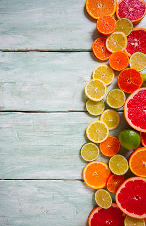 citrus fruit slices on turquoise backgroundの写真素材