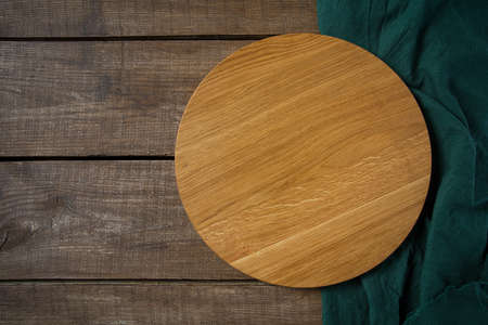 round cutting board on wooden surfaceの写真素材