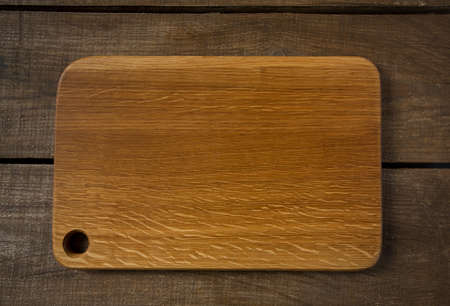 empty cutting board on wooden surfaceの写真素材