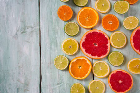 citrus fruit slices on turquoise backgroundの写真素材