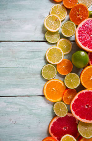 citrus fruit slices on turquoise backgroundの写真素材