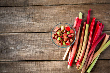 rhubarb stems on wooden surfaceの写真素材