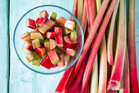 rhubarb stems on wooden surfaceの写真素材