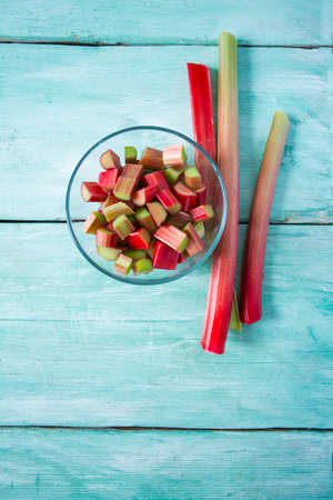 rhubarb stems on wooden surfaceの写真素材