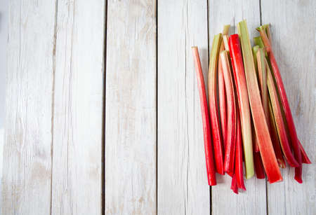 rhubarb stems on wooden surface