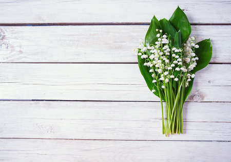 lilly of the valley flowers on wooden surfaceの写真素材
