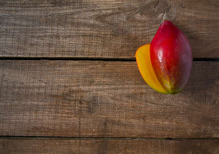 mango fruit on wooden surfaceの写真素材
