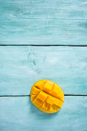 mango fruit on turquoise wooden surface