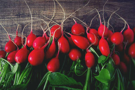 fresh radishes on wooden surface