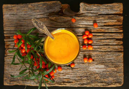 sea buckthorn tea on wooden surfaceの写真素材