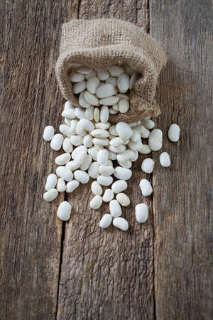 white butter beans on wooden surfaceの写真素材
