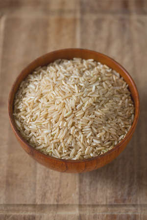 Brown rice in a bowl on wooden ÑÐ³ÐºÐ°ÑÑÑの写真素材