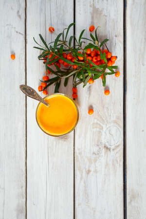 sea buckthorn tea on wooden surface