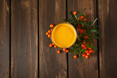 sea buckthorn tea on wooden surfaceの写真素材