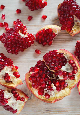 pomegranate seeds on wooden surfaceの写真素材