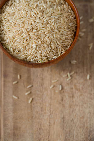 Brown rice in a bowl on wooden ÑÐ³ÐºÐ°ÑÑÑの写真素材
