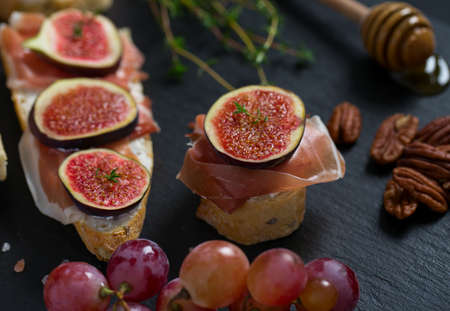 whole bread with cheese, parma ham and figsの写真素材