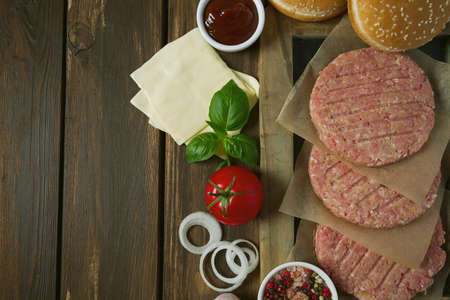 Burger patties on wooden surfaceの写真素材