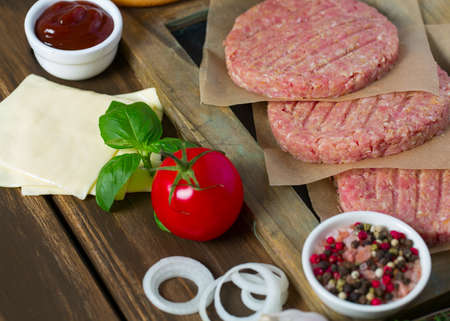 Burger patties on wooden surfaceの写真素材