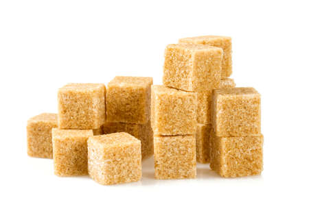 Brown sugar cubes isolated on whiteの写真素材