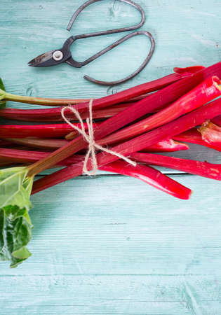 fresh rhubarb on wooden surface