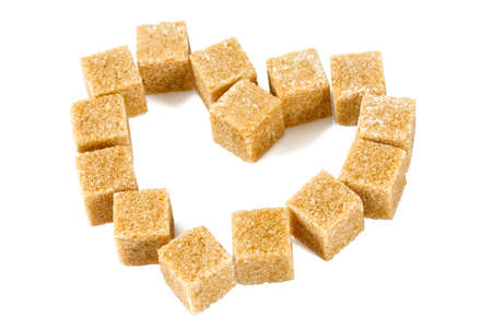 brown sugar cubes isolated on whiteの写真素材