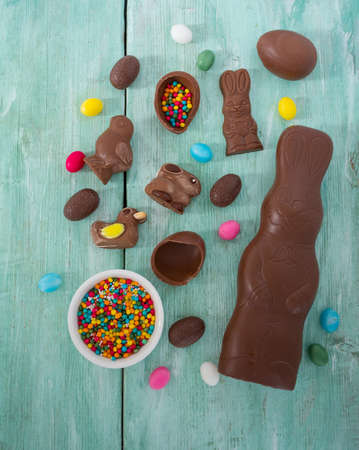 Easter composition with chocolate eggs and animals on wooden surfaceの写真素材