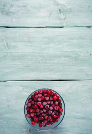 frozen cranberries on wooden surfaceの写真素材