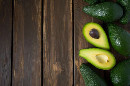 avocado on dark wooden surface