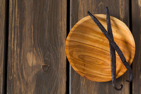 vanilla beans on wooden bowl