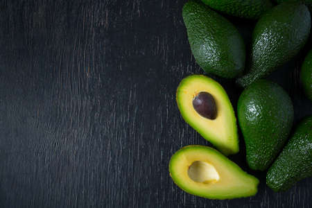 avocado on dark wooden surface