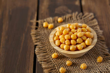 chickpeas on blue wooden surfaceの写真素材
